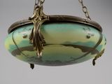 a hanging light that has a bird on it