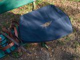 a blue bag sitting on a green bench next to a green bench