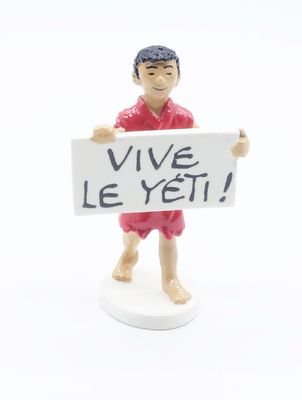 a small figurine of a man holding a sign