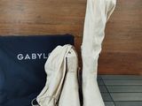 a pair of white boots and a bag on the floor