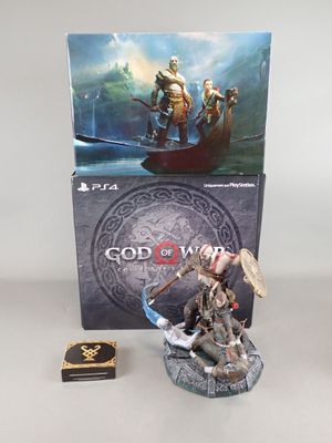 two figurines of god of war and a box of cards