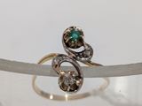 a close up of a ring with a green stone
