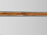 a picture of a wooden and metal sword with a wooden handle
