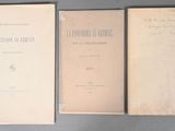 three old books sitting on top of a table next to each other