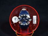 a blue watch in a red case on a black background