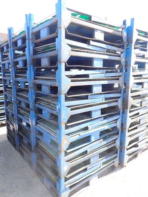 many pallets stacked on top of each other on the ground