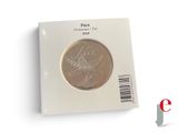 a picture of a coin in a package on a white surface