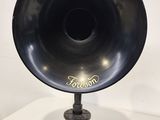 an old fashioned black gramphone on a stand with a white background