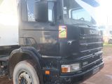 a black and white dump truck parked in a lot