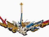 un groupe d'engins de chantier et une grue sur fond blanc