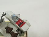 a toy of a telephone and a pair of shoes in a box