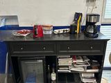a black cabinet with a coffee maker on top of it