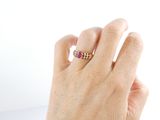 a woman ' s hand with a ring on it ' s finger