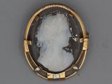 an image of a picture of a woman ' s profile in a gold frame