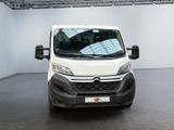 the white van is parked in a white room with a black floor
