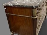 an antique chest of drawers with marble top and brass handles