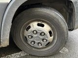 a white van that has a flat tire on the street