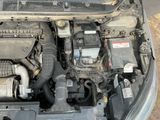 the engine of a car with its hood open and the hood down