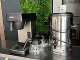 a picture of a coffee maker and a coffee pot on a counter