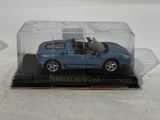 a blue toy car in a clear box on a table