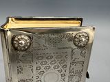 a silver book that is sitting on a table