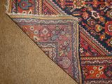 a close up of a rug on a brown surface