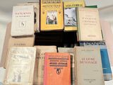 many books stacked on top of each other on a table
