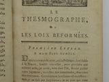 an open book with a picture of a building in the background