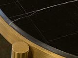 a close up of a black and gold table with a black marble top