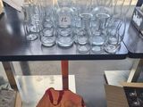 bottles and glasses on a table with a bag of wine in front of them