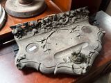 a metal plaque on a table next to a lamp