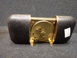a black and gold case with a gold coin on it