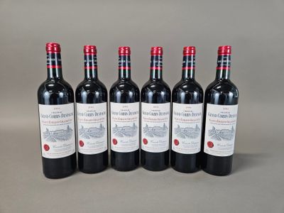 six bottles of red wine lined up in a row