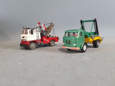 two toy trucks that are sitting next to each other