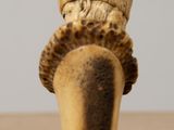 a close up of a wooden object with a hat on it