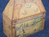 a wooden box with a painting on it on a blue carpet