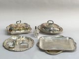 four pieces of silverware including a tray, tray, and spoon