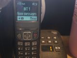 a cell phone sitting on a desk next to a cup of coffee