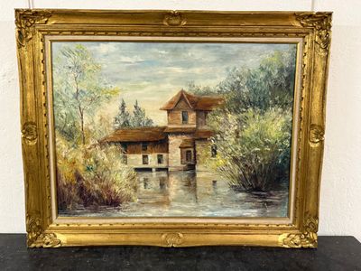 an oil painting of a house by a river in a gold frame
