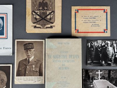 an old photo of a group of military memorabilias on a table