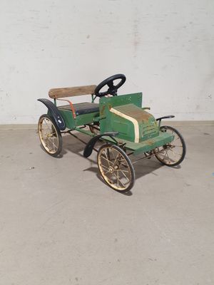 a green toy car that is sitting on the ground