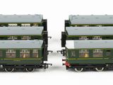 two green and white train cars sitting side by side