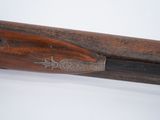 an old wooden rifle with a wooden handle on a white surface