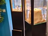 a fish tank in the middle of a room with a ladder next to it