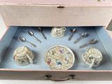 a box with a tea set in it on a table