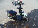 a scooter that is parked on the side of the street