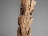 an old wooden statue of a woman with her head turned to the side