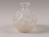 a white glass vase with a design on it