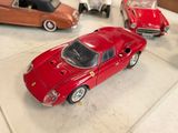 several toy cars are lined up on a white surface