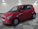 the small red car is parked in the garage on a checkered floor
